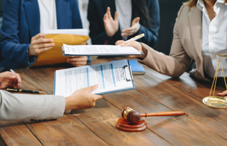 Business people and lawyers discussing contract papers sitting at the table.