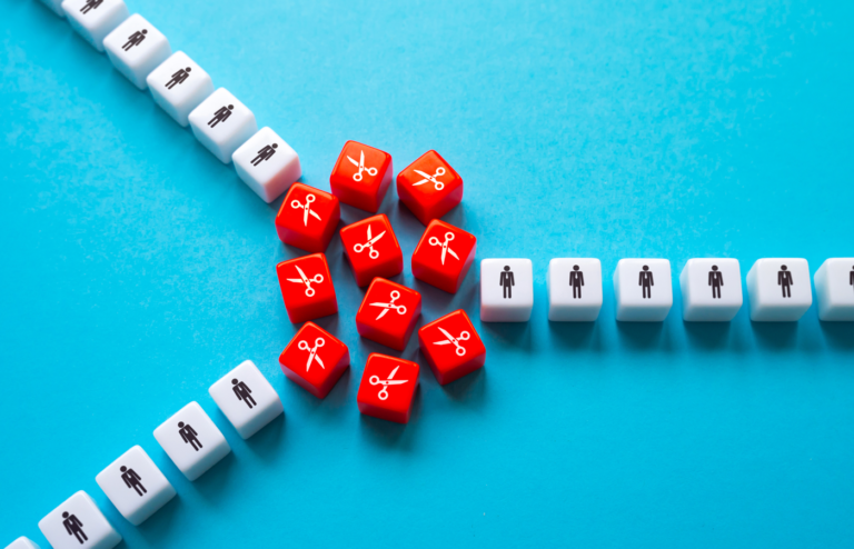 White dice with person icon and red dice with scissors icons on a blue background.