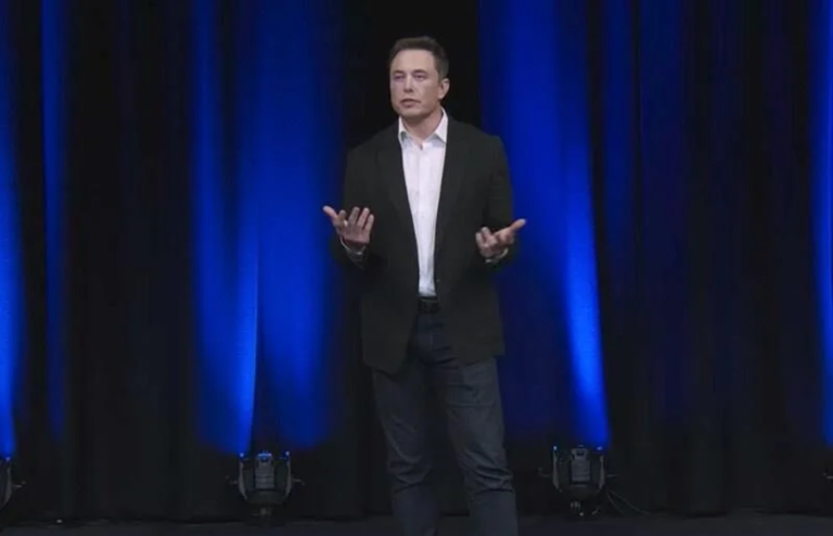 A photo of Elon Musk speaking on a stage.